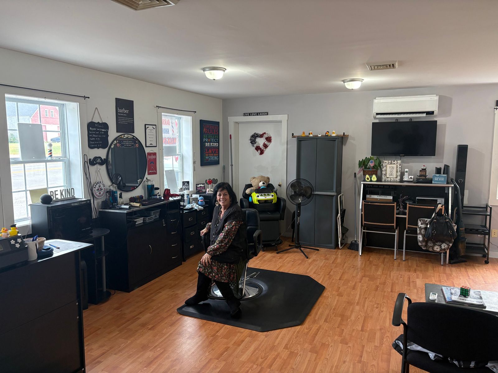 Ivette sitting in the barber chair inside her shop